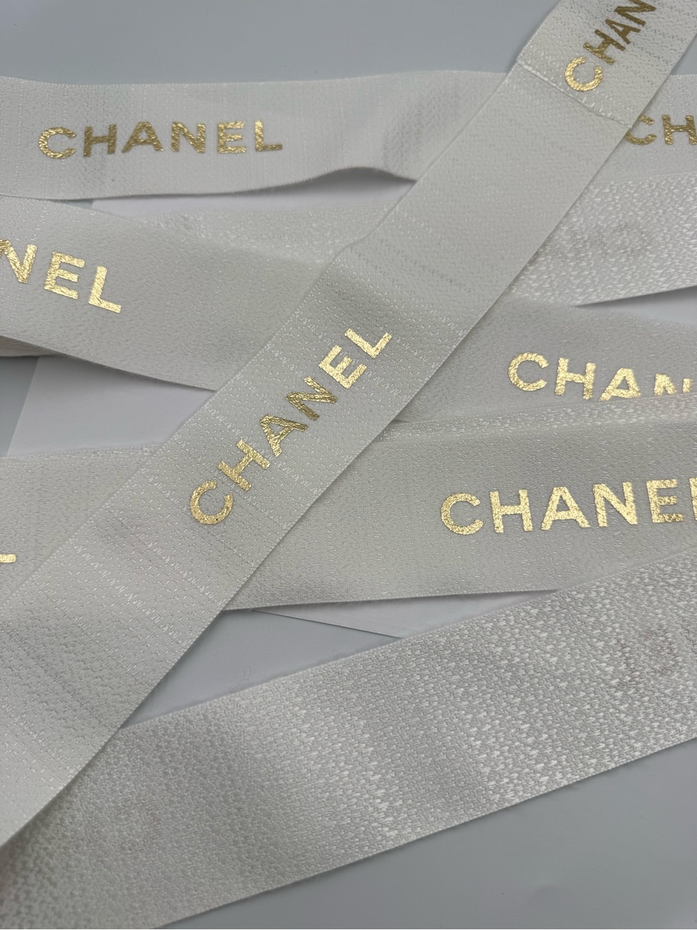 CHANEL White Ribbon with Gold Logo